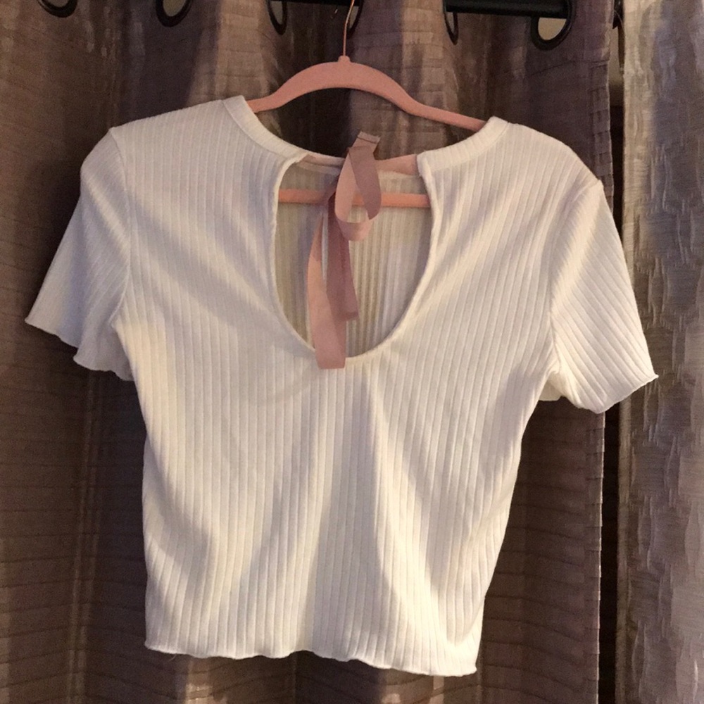 White shirt sleeve with pink bow in back